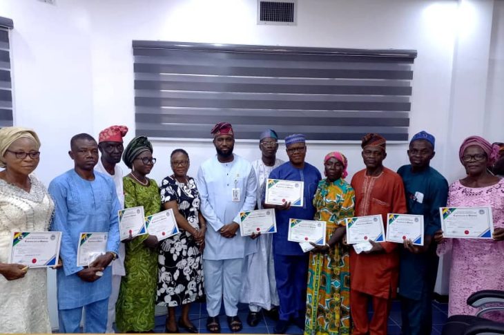 At the centre is the Managing Director Lagos Water Corporation Engr Mukhtaar Tijani next left is the Executive Director Operations Engr Mrs Omolanke Taiwo and the retirees with their Certificates of Service.