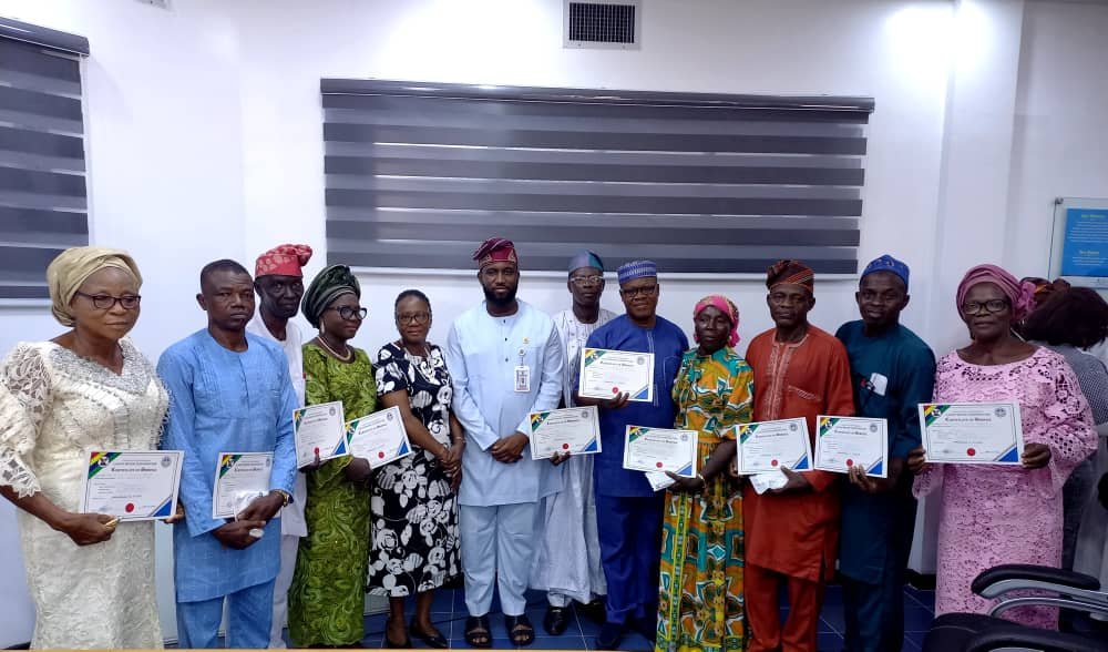 At the centre is the Managing Director Lagos Water Corporation Engr Mukhtaar Tijani next left is the Executive Director Operations Engr Mrs Omolanke Taiwo and the retirees with their Certificates of Service.